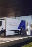 Man charging a Renault Trucks E-Tech D