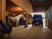 Renault Trucks Master Red EDITION Exclusive - van at the entrance to a stable for a delivery, a rider brushes her horse