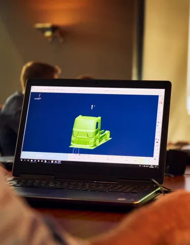 Meeting with the design team, with a 3D truck on a screen